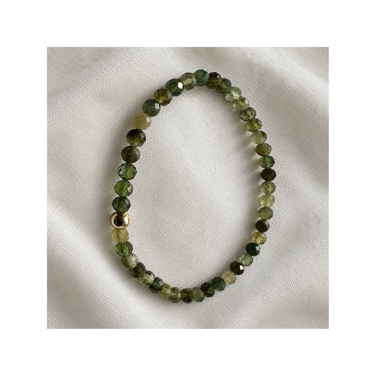 Close-up of FOREST GREENS green tourmaline bracelet and its natural moss and olive gemstone colours