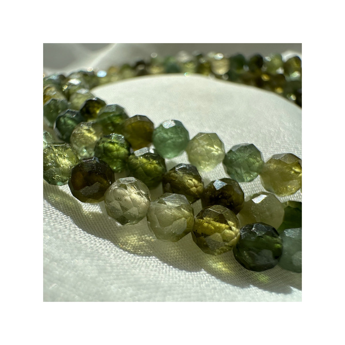 FOREST GREENS natural green tourmaline necklace styled in a close-up model photograph