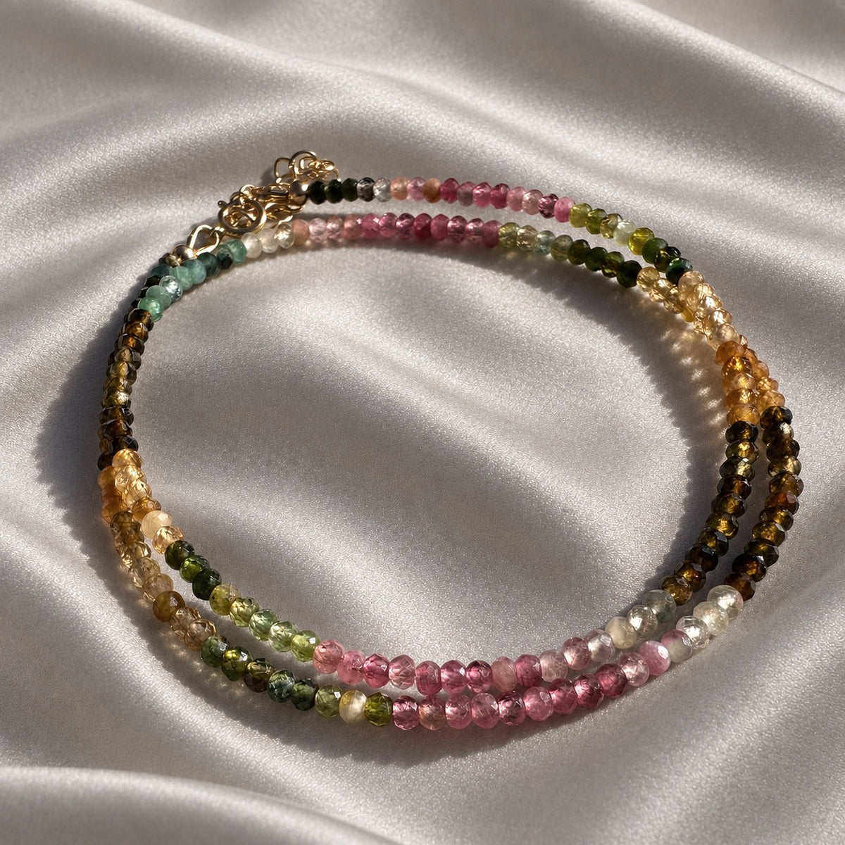 AFTER HOURS multicolour tourmaline necklace arranged in a double loop, with pink, green and cognac faceted beads on pearl-grey silk